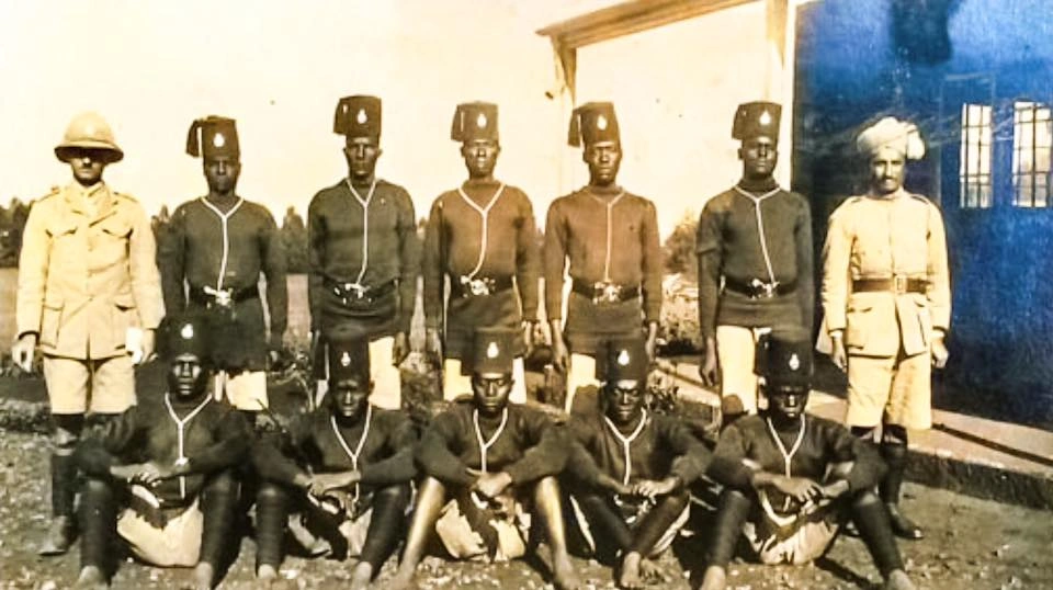 Kenya officially becomes a Crown Colony (1920)_A photo shot of a Nyeri colonial administrative officer with native and Asian police officers 1926.webp