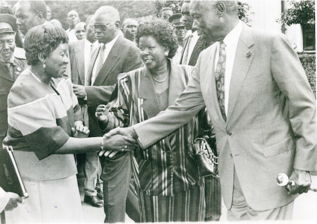 President Daniel Arap Moi greets MYWO chairlady Zipporah Kittony during the opening of the organisations governing council meeting as culture and social services minister Nyiva Mwendwa looks on. MAY 1997