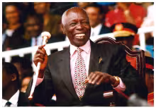 President Daniel Arap Moi laughing during Madaraka Day Celebrations at Nyayo Stadium